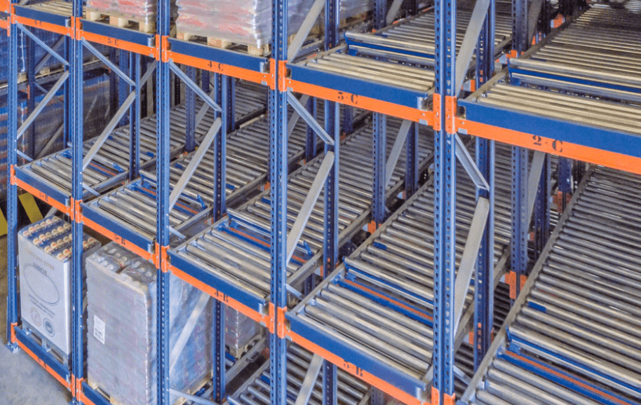 Pallet flow racking system in a warehouse — gravity-fed roller conveyor lanes for FIFO inventory rotation at high density