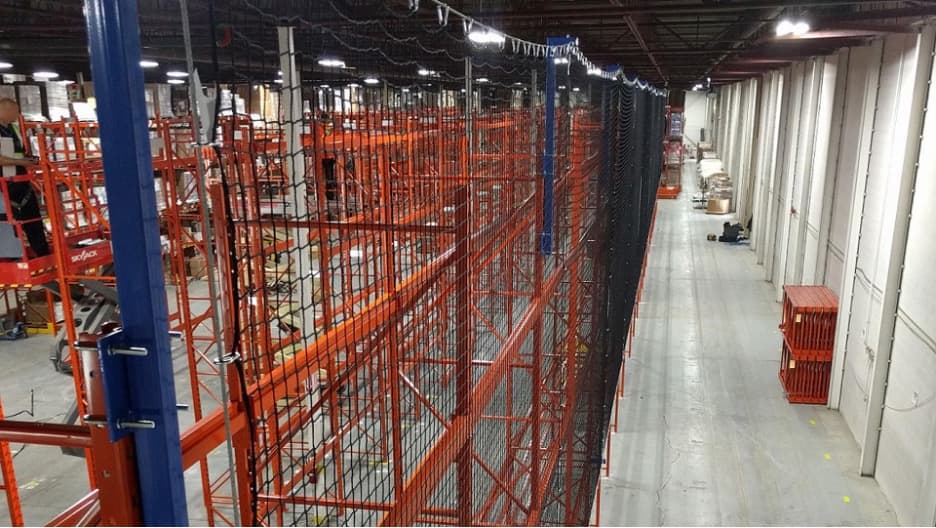 Warehouse safety netting installed on elevated pallet racking to prevent falling product and debris