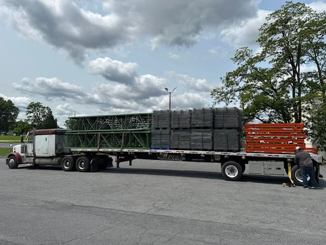 Pallet racking disassembly and removal in progress — KWI crew safely decommissioning an existing warehouse rack system